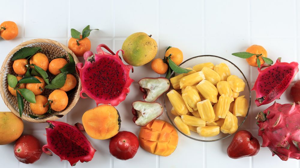 Top View Various Tropical Fruit, Mango, Dragon Fruit, Peelede jackfruit, Orange, and Water Guava