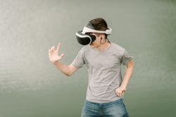 Young teenager with virtual reality glasses outdoors