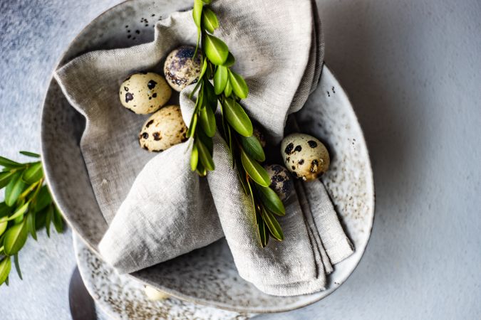 Easter card concept with elegant grey ceramic bowl and speckled eggs and copy space