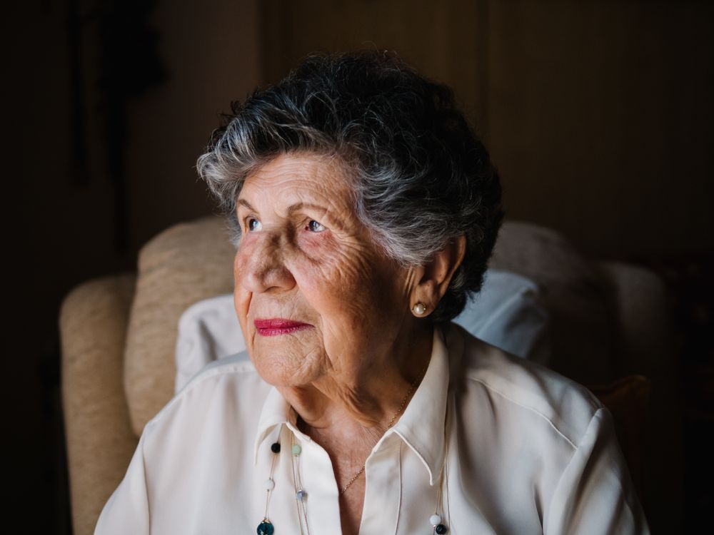 Portrait of mature female in white shirt at home