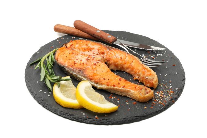 Plate with grilled salmon isolated on blank background