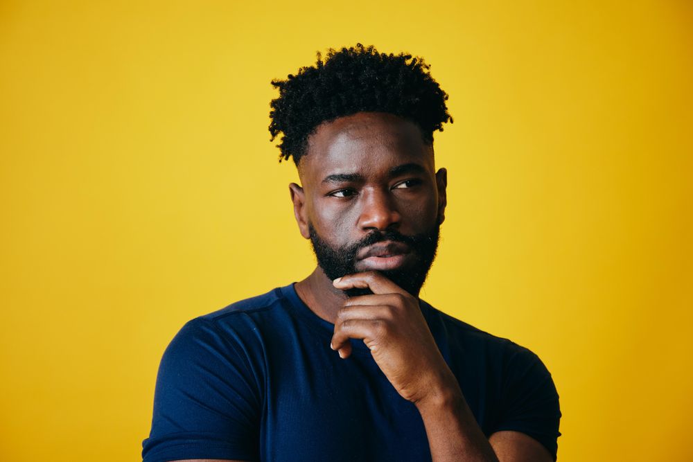 Portrait Of Black Guy Covering Eyes With Hearts, Yellow Background Stock  Photo - Alamy