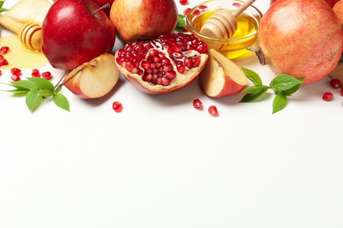 Top view of fresh apples, pomegranate and honey with copy space