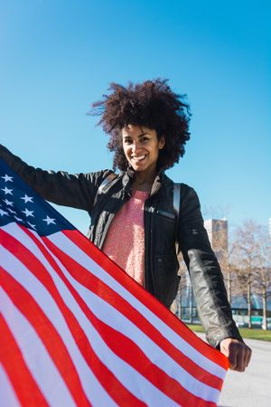 Black woman with afro hair and an american flag