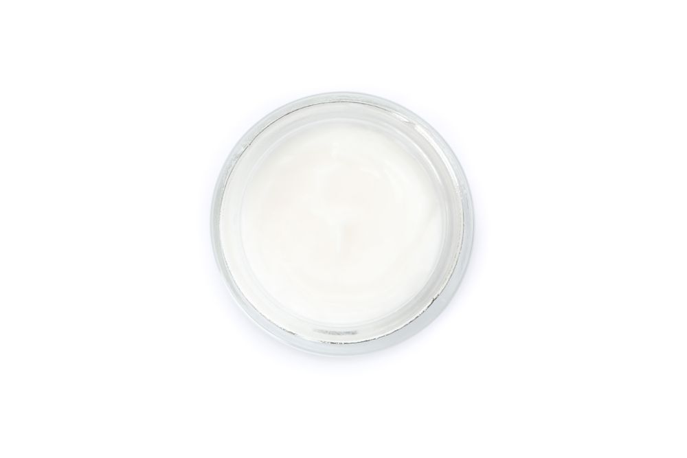 Cosmetic cream in glass jar isolated on plain background