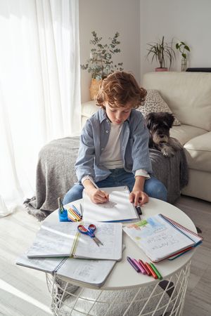 Boy drawing on paper at home