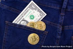 Bitcoins and dollar bill in denim pocket 5wKXA5