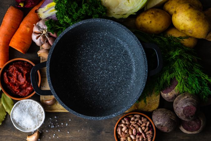Top view of fresh ingredients for borscht soup surrounding pan