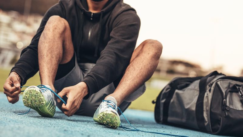 Athlete wearing sports shoes getting ready for training