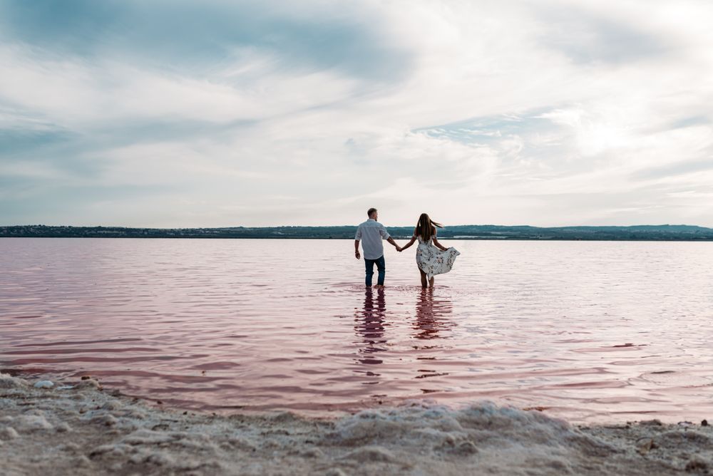 back view of adorable into an amazing beach with pink water