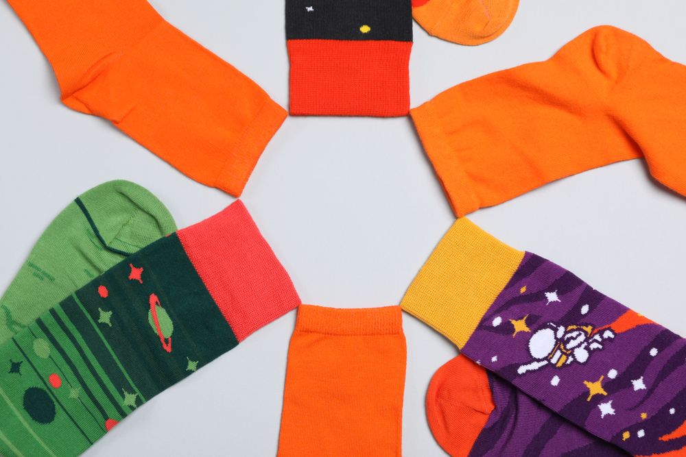 Casual clothes and wearing concept - socks, clothes for foot