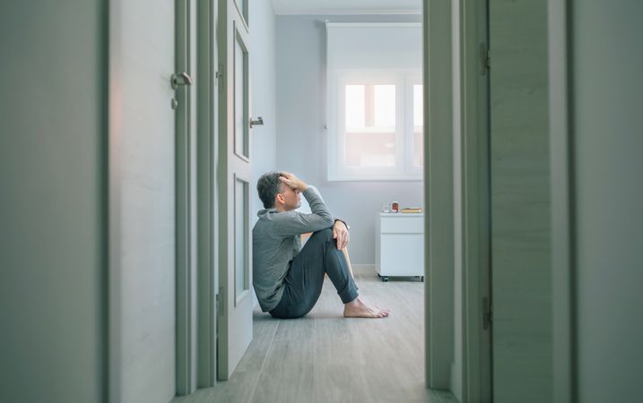 Man sitting on room floor