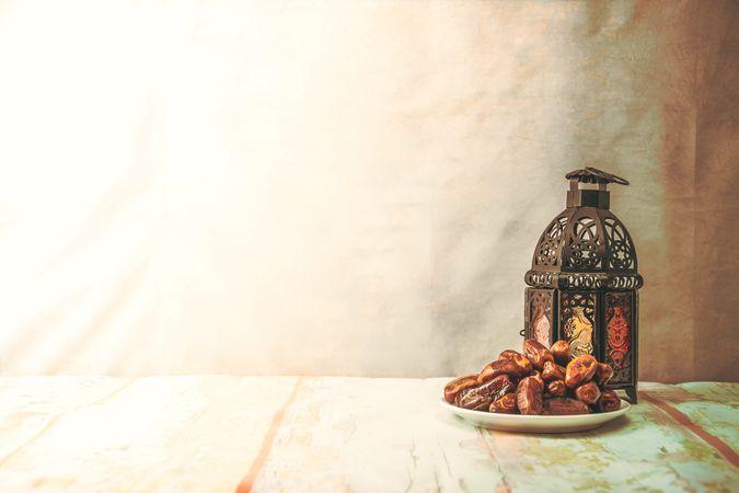 Traditional Lantern and Plate of Dates on Rustic Table