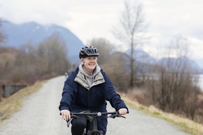 Woman smiling while riding a bicycle