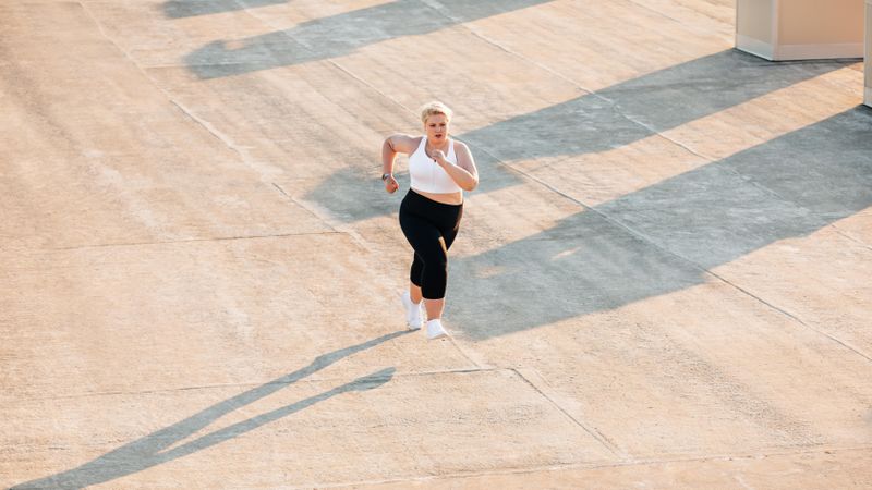Athletic woman running on a roof