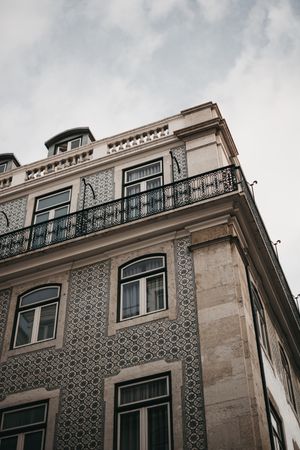 Corner of building against cloudy sky