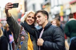 Female taking selfie with her boyfriend in UK street