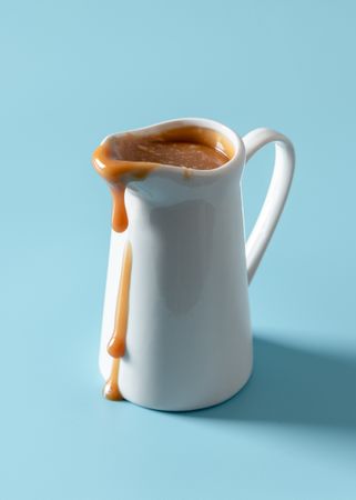 Caramel jug isolated on a blue background