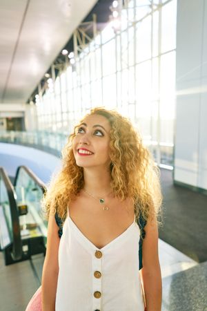 woman walking in spacious hall in sunlight