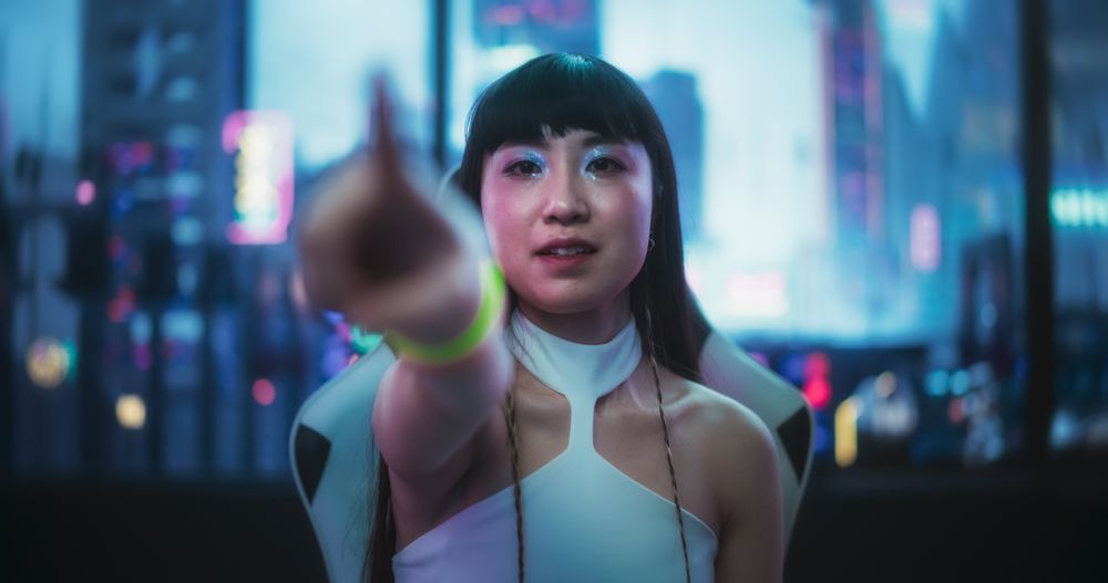 Stylish Japanese Young Woman Interacting with Augmented Reality Platform in a Technologically Advanced Room with Futuristic Cyberpunk City in the Background.