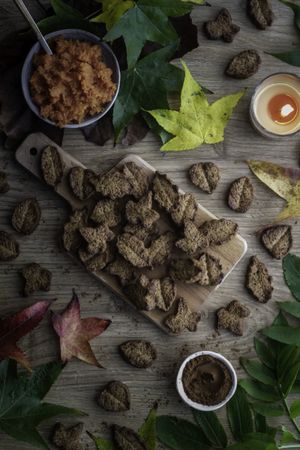 Yummy cookies and leaves on table