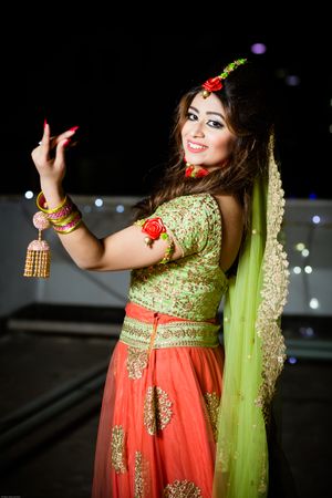 Woman in green and red costume dancing