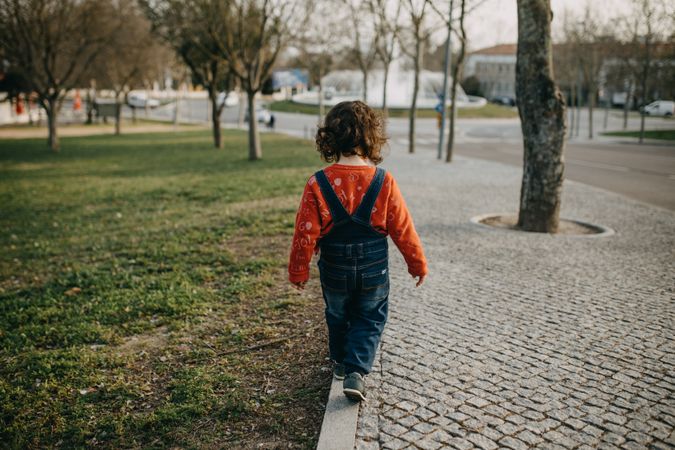 Child walking on a path in the park