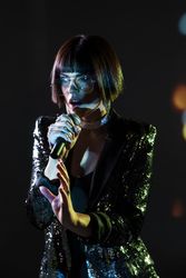 Stylish woman singing on stage