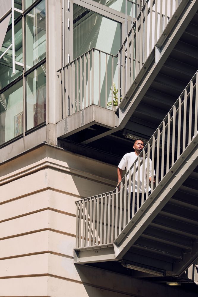 Black male standing on bridge