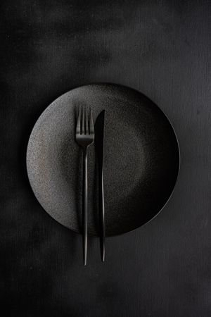 Table setting with dark plate and silverware