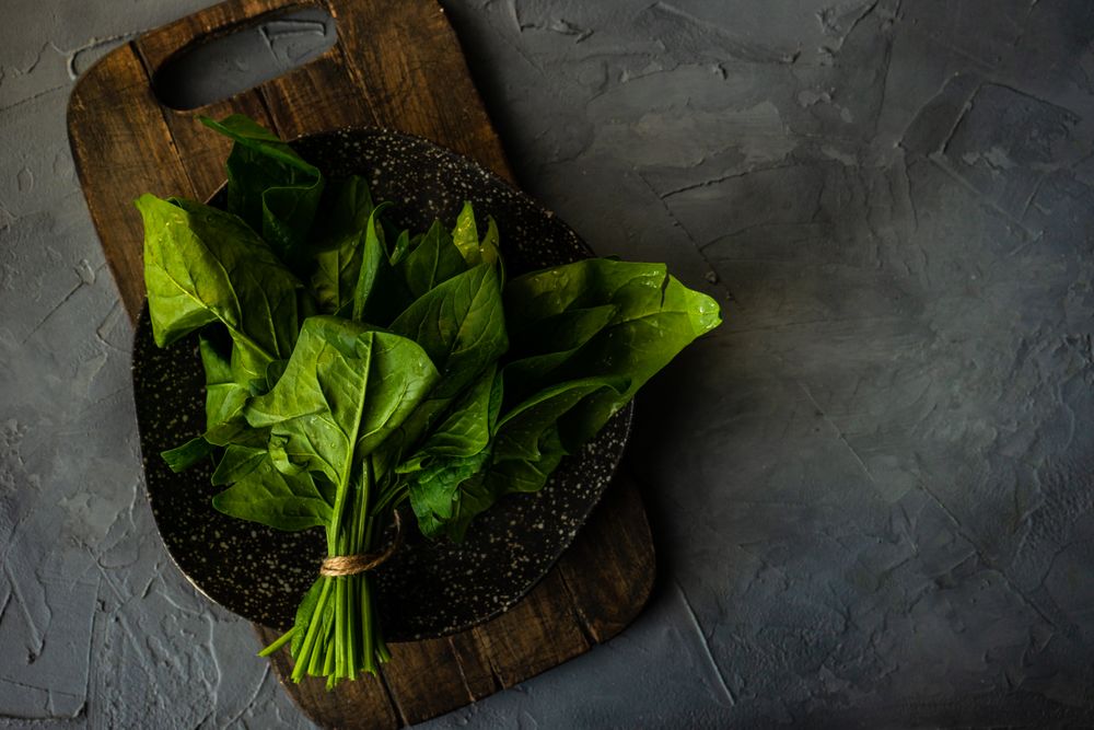 Top view of fresh spinach wrapped on plate