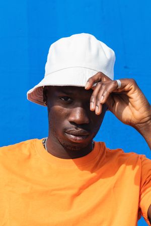 Black man in bright sporty outfit and cap