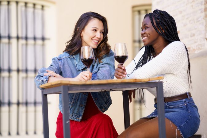 Young women enjoying a glass of wine together