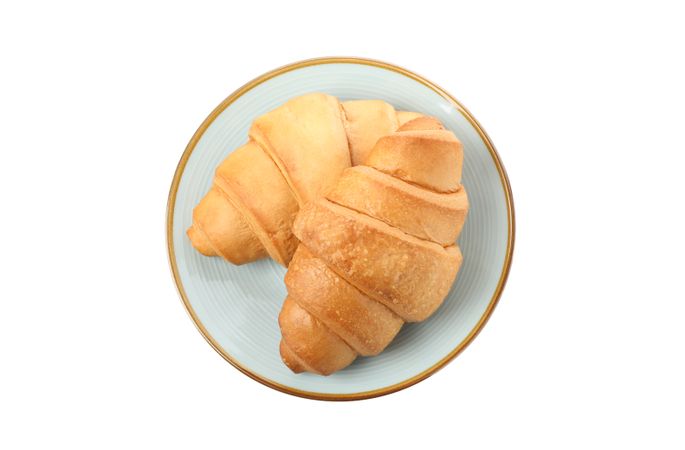 Top view of plate with two croissants isolated on plain background