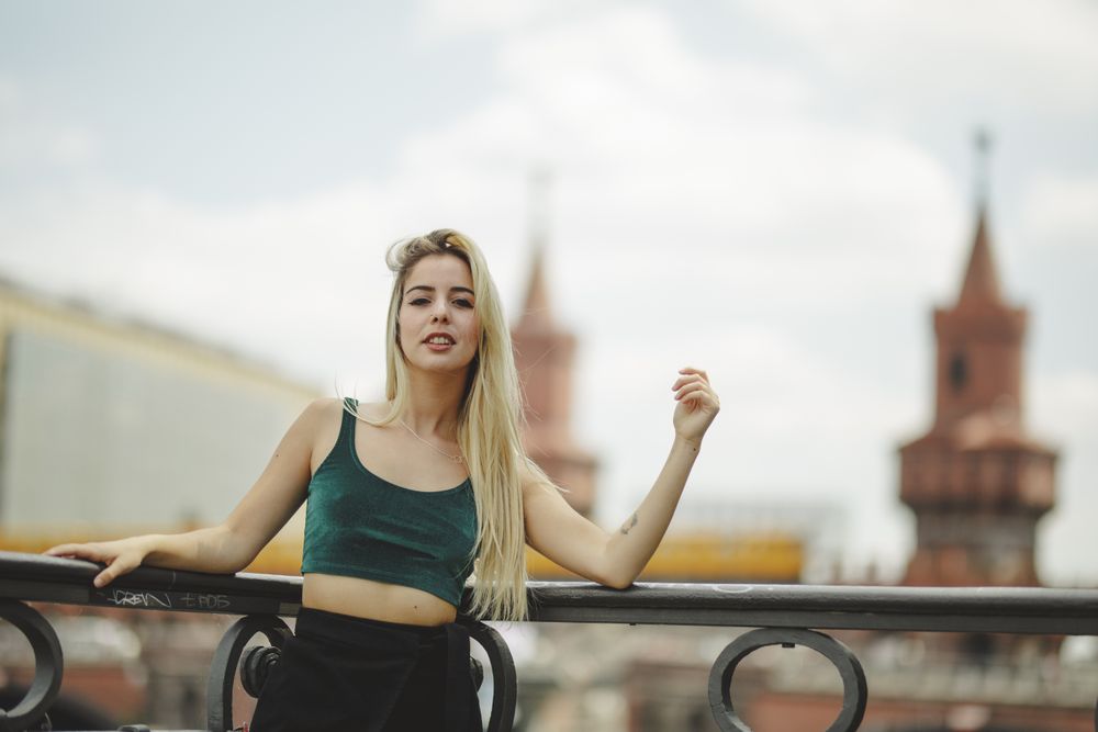 Blonde woman leaning on railing
