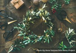 Olive branch festive wreath with scissors and holiday decorations, horizontal composition 0Ljyy4