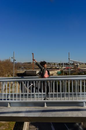 Woman with afro hair jumping for joy in the streets.