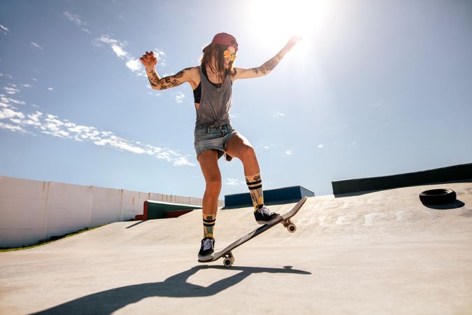Women doing tricks on skateboard