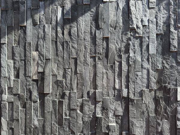 Texture of grey tiled slab wall