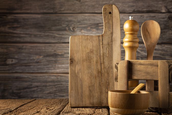 Wooden kitchen utensils on rustic background.