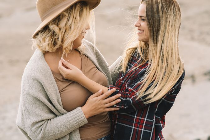 Content blond women cuddling on nature