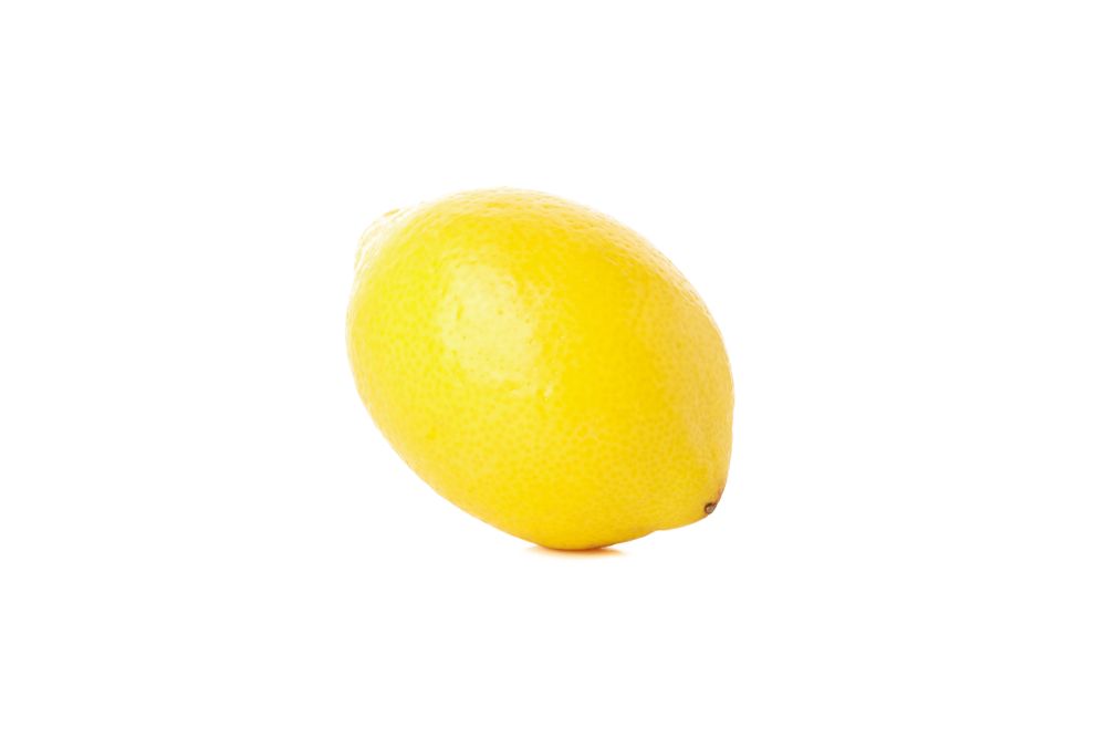 Fresh lemon isolated on light background. Ripe fruit