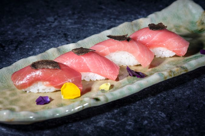 Tasty sushi of rice and tuna on plate