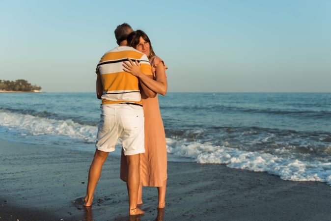 Adult couple embracing near sea