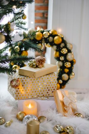 Christmas gift boxes and garland and tree decorated with gold baubles