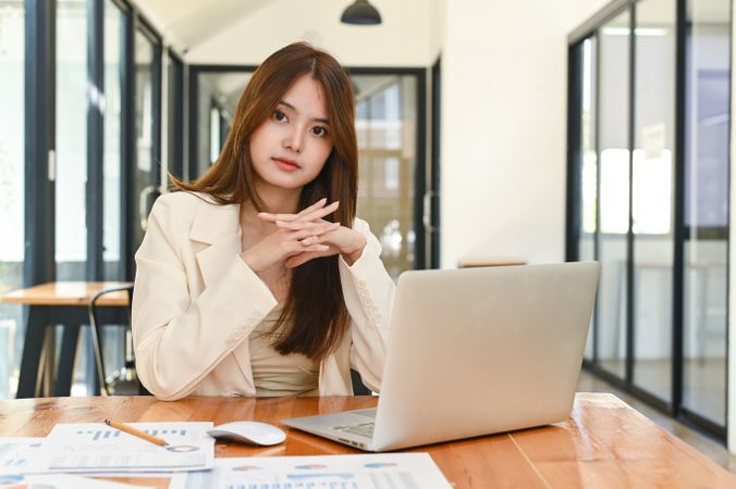 Young Asian businesswoman with laptop in office.
