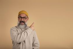 Smiling man pointing to his side