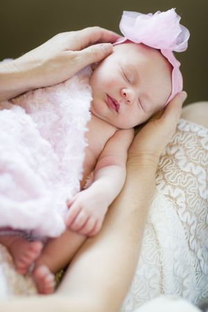 Hands of Mom Holding Her Newborn Baby Girl