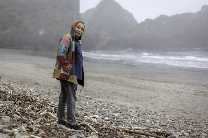 Older man on empty ocean seashore