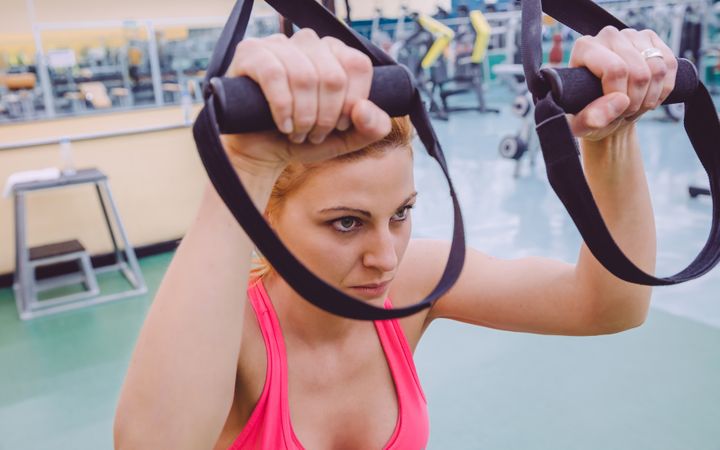 Close up of woman using equipment in gym